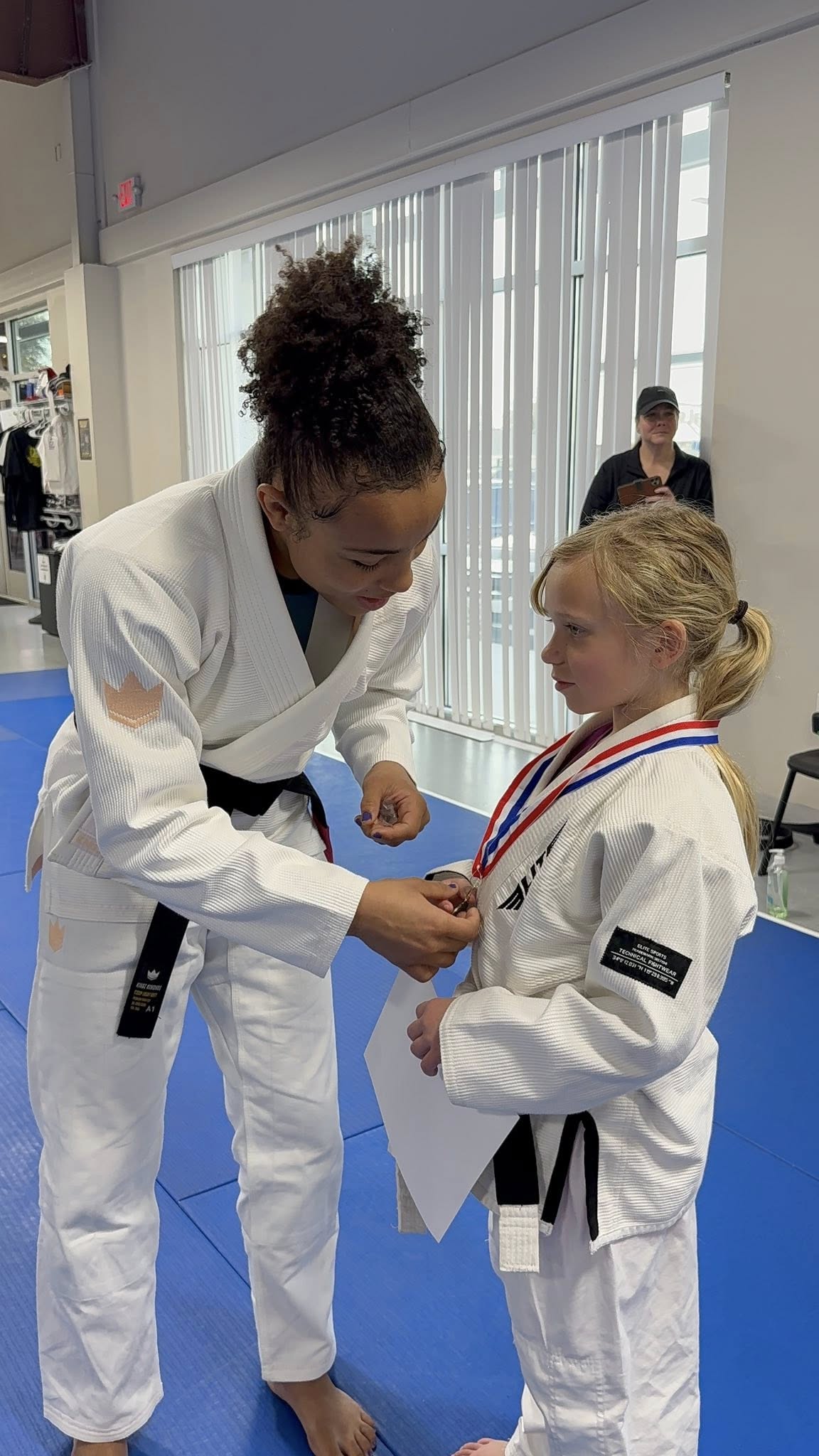Bastos BJJ student with competition medal