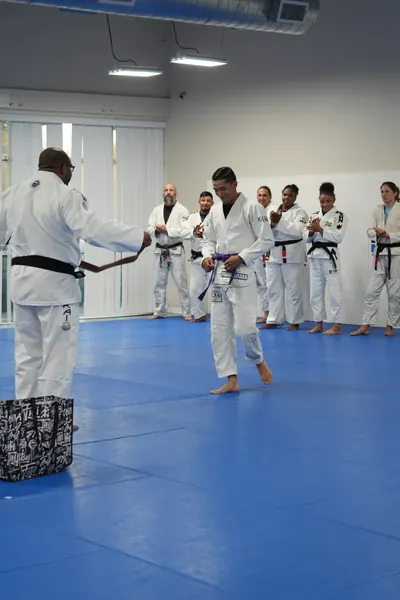 Belt promotion ceremony at Bastos BJJ Midland — student receiving rank advancement